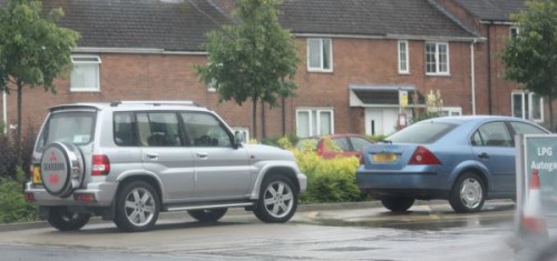 Several empty cars were parked around the forecourt.