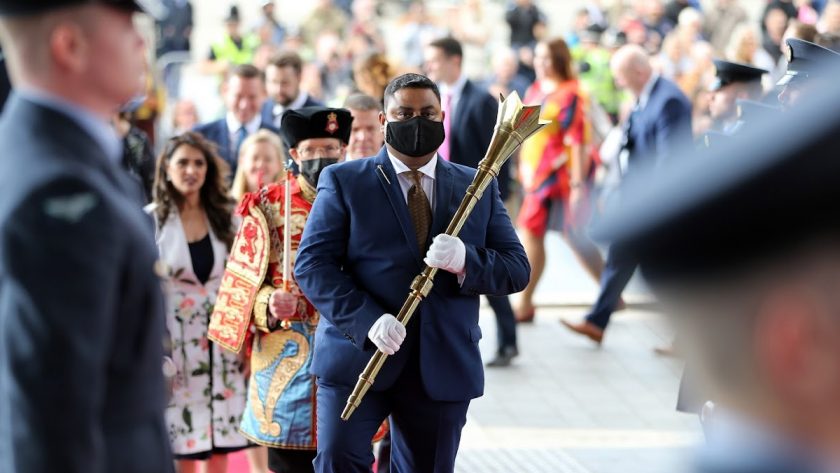 Member of the Senedd’s security team, Shahzad Khan, arrives with the Mace at the Official Opening of the Sixth Senedd.
