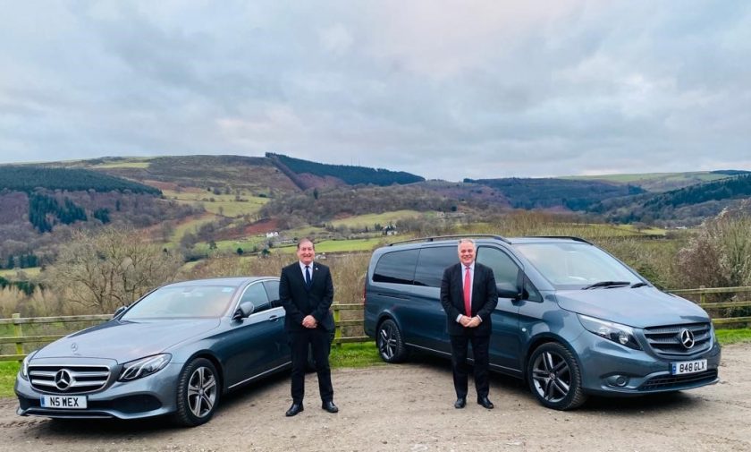 Chris Millward-Hopkins, of North East Wales Executive Transfers, and Simon Baynes MP in front of two NEW Executive Transfers cars at The Sun Trevor on Friday 21st January 2022.